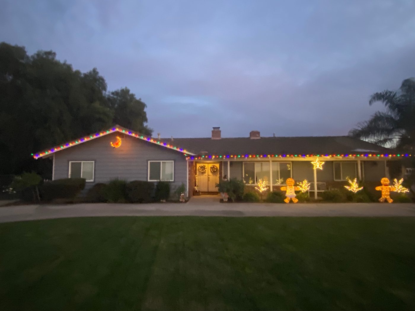Ranch home in San Diego County with roofline lights and gingerbread man yard decor